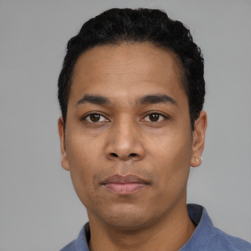 Neutral latino young-adult male with short  black hair and brown eyes
