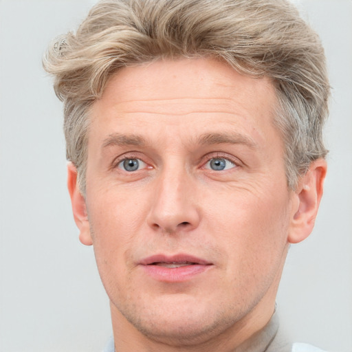 Joyful white adult male with short  brown hair and grey eyes