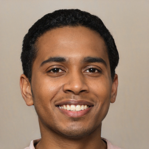 Joyful black young-adult male with short  black hair and brown eyes