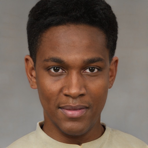 Joyful black young-adult male with short  brown hair and brown eyes