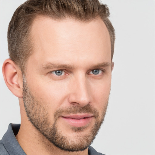 Joyful white adult male with short  brown hair and grey eyes