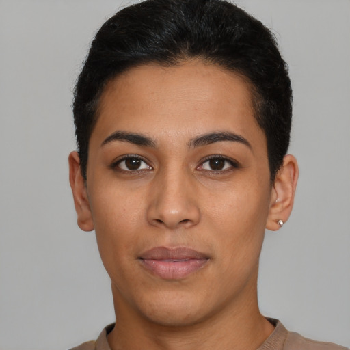 Joyful latino young-adult female with short  black hair and brown eyes