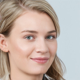 Joyful white young-adult female with long  brown hair and blue eyes