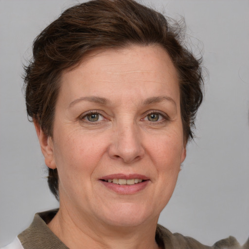 Joyful white adult female with short  brown hair and grey eyes