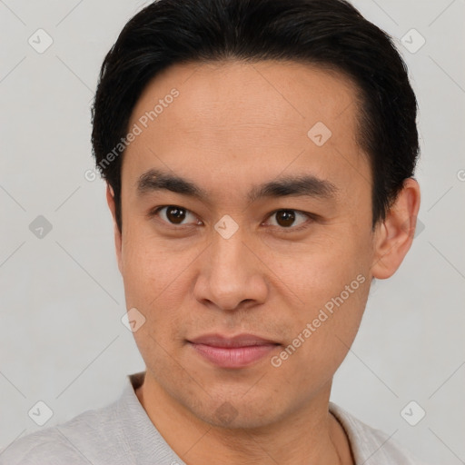 Joyful asian young-adult male with short  brown hair and brown eyes