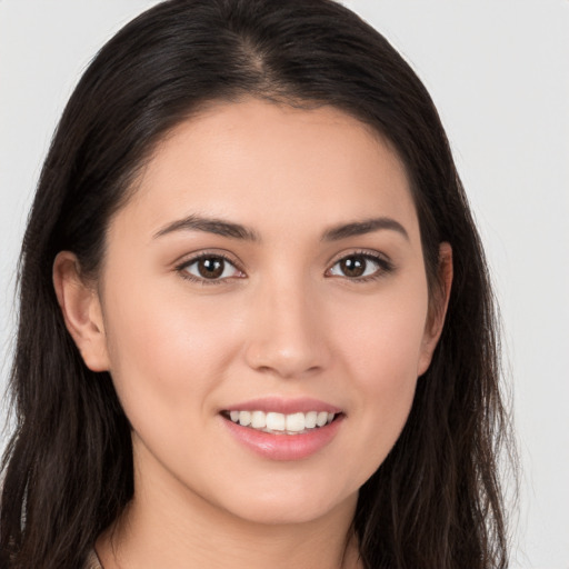 Joyful white young-adult female with long  brown hair and brown eyes