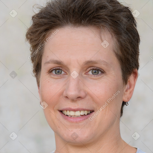 Joyful white adult female with short  brown hair and brown eyes