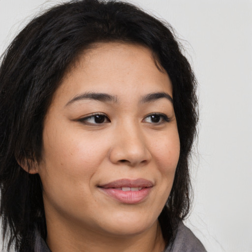 Joyful latino young-adult female with long  brown hair and brown eyes