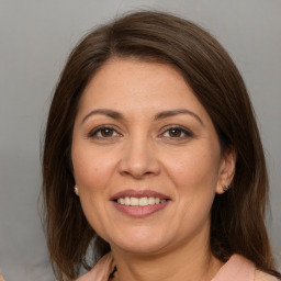 Joyful white adult female with medium  brown hair and brown eyes