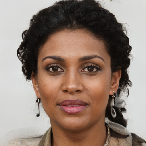 Joyful black young-adult female with long  brown hair and brown eyes