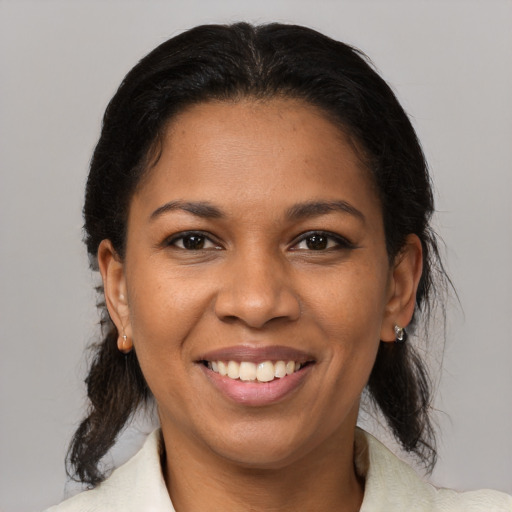 Joyful black young-adult female with medium  brown hair and brown eyes