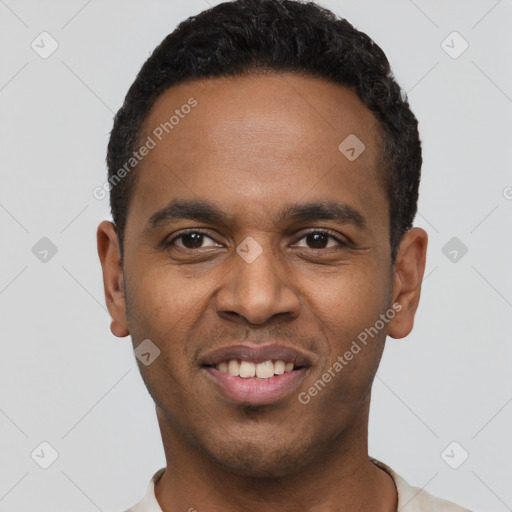 Joyful black young-adult male with short  black hair and brown eyes