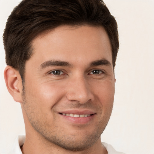 Joyful white young-adult male with short  brown hair and brown eyes