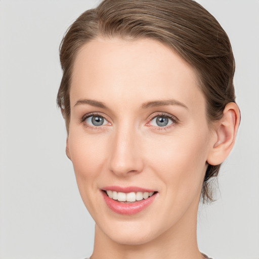 Joyful white young-adult female with short  brown hair and grey eyes