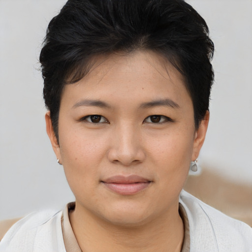 Joyful asian young-adult female with short  brown hair and brown eyes
