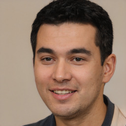 Joyful white young-adult male with short  black hair and brown eyes