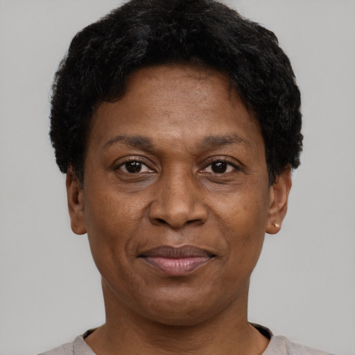 Joyful black adult female with short  brown hair and brown eyes