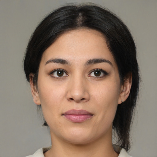 Joyful latino young-adult female with medium  black hair and brown eyes