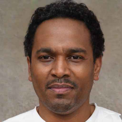 Neutral latino adult male with short  black hair and brown eyes
