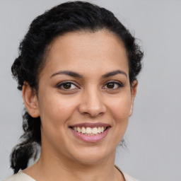 Joyful latino young-adult female with short  brown hair and brown eyes