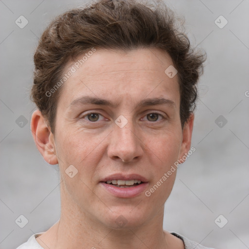 Joyful white adult male with short  brown hair and grey eyes