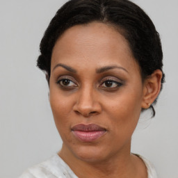 Joyful black adult female with short  brown hair and brown eyes