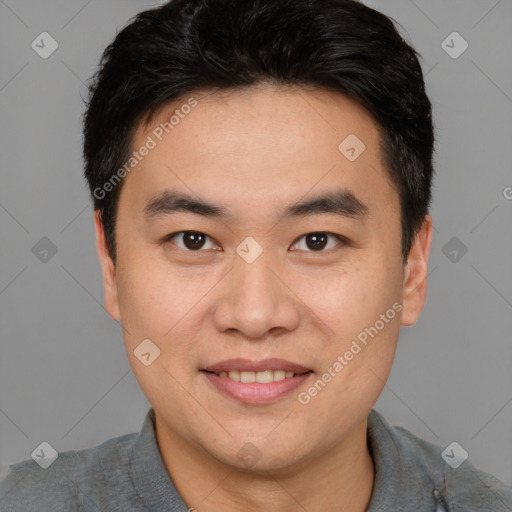 Joyful asian young-adult male with short  brown hair and brown eyes