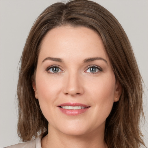 Joyful white young-adult female with medium  brown hair and grey eyes