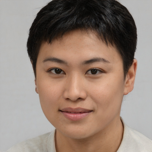 Joyful asian young-adult female with short  brown hair and brown eyes