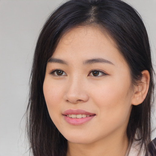 Joyful asian young-adult female with long  brown hair and brown eyes