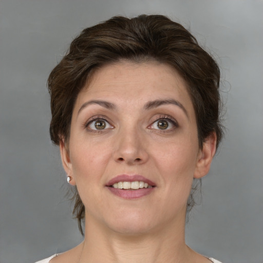 Joyful white adult female with medium  brown hair and green eyes