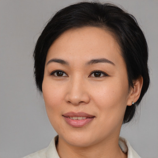 Joyful asian young-adult female with medium  brown hair and brown eyes