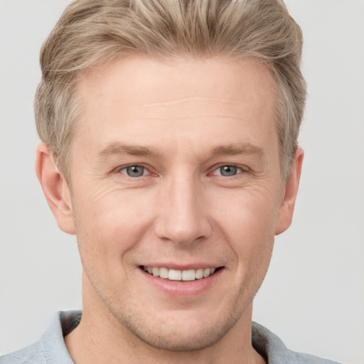 Joyful white adult male with short  brown hair and grey eyes