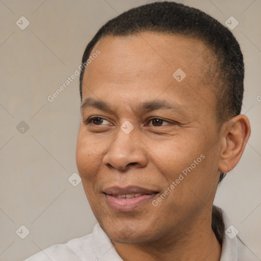 Joyful latino adult male with short  brown hair and brown eyes