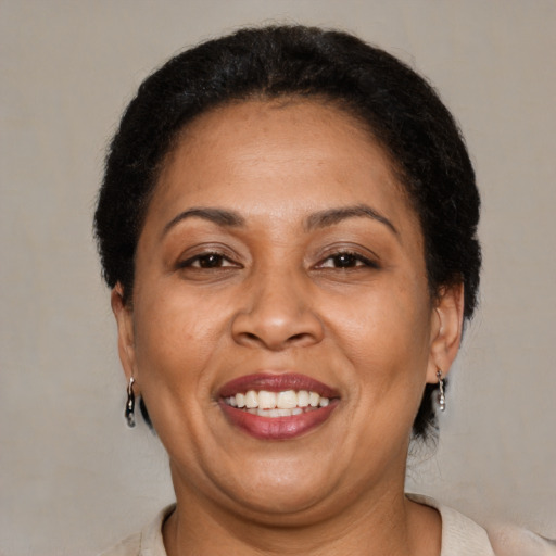Joyful latino adult female with short  brown hair and brown eyes
