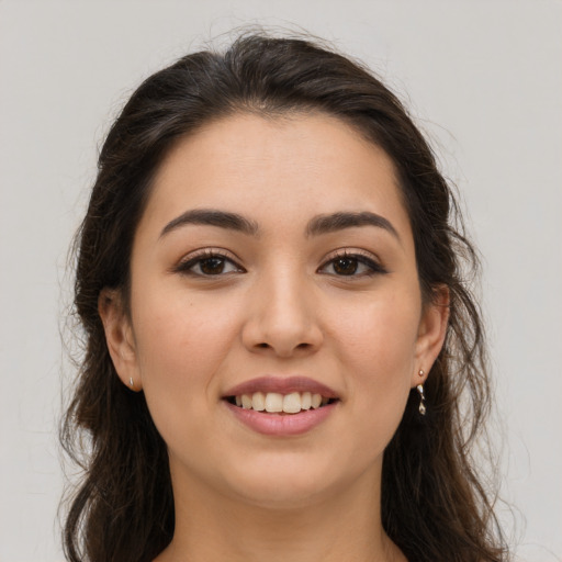 Joyful white young-adult female with long  brown hair and brown eyes