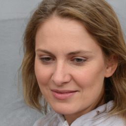 Joyful white young-adult female with medium  brown hair and blue eyes