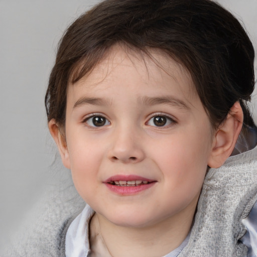 Joyful white child female with short  brown hair and brown eyes