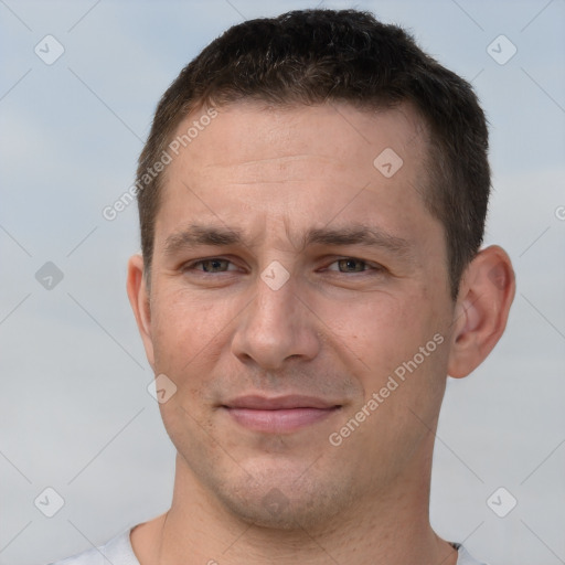 Joyful white adult male with short  brown hair and brown eyes