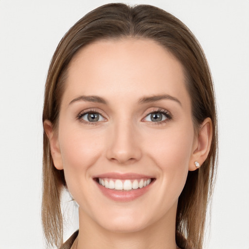 Joyful white young-adult female with long  brown hair and blue eyes