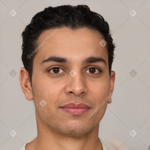 Joyful latino young-adult male with short  brown hair and brown eyes