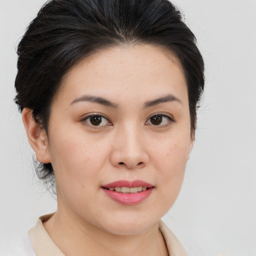 Joyful asian young-adult female with medium  brown hair and brown eyes