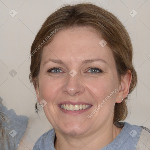 Joyful white adult female with medium  brown hair and blue eyes