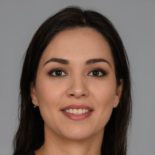 Joyful white young-adult female with long  brown hair and brown eyes