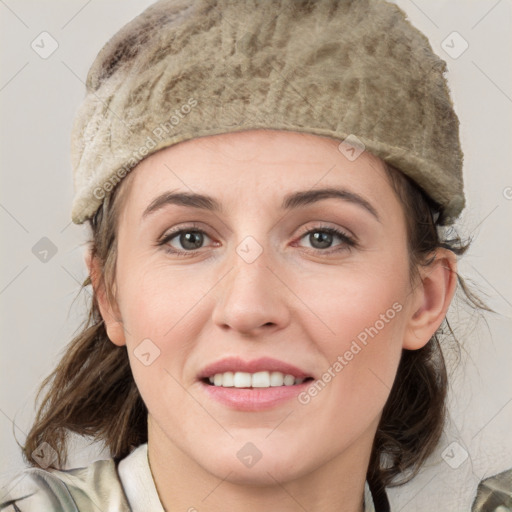 Joyful white young-adult female with medium  brown hair and grey eyes