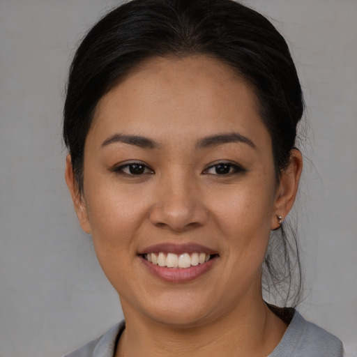 Joyful asian young-adult female with medium  brown hair and brown eyes
