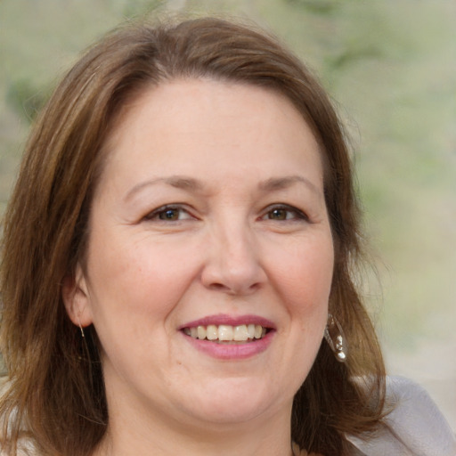 Joyful white adult female with medium  brown hair and grey eyes