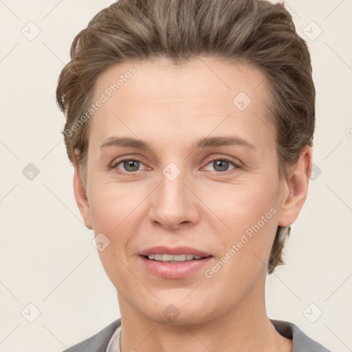 Joyful white young-adult female with short  brown hair and grey eyes