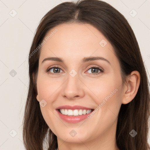 Joyful white young-adult female with long  brown hair and brown eyes