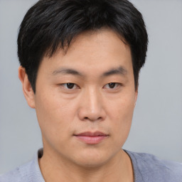 Neutral asian young-adult male with short  brown hair and brown eyes